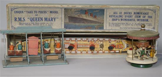 A boxed Queen Mary model and two miniature wooden fairground toys